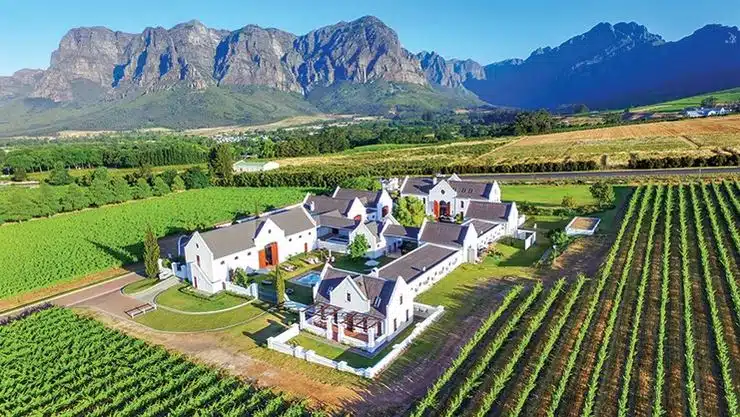 Stellenbosch wine estate buildings surrounded by vineyards and mountains