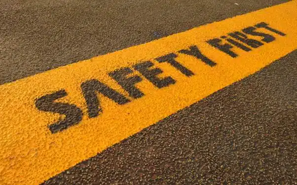 Safety First message painted on a road